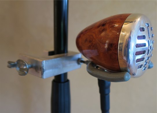 A wood bullet mic perched on an old-style clamp mount